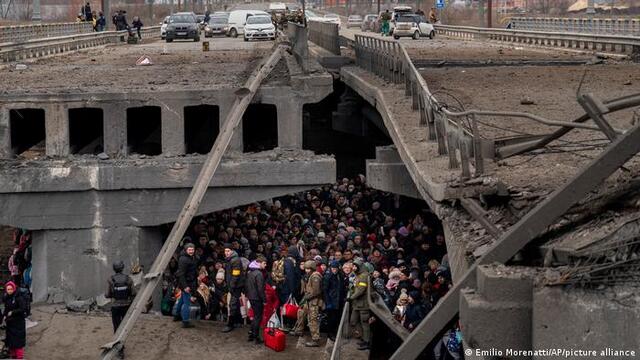 Зруйнований міст в Ірпені. Під ним - люди, які хочуть евакуюватися. Сховалися від бомбардувань. Фото AP
