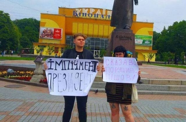 Зліва -- Роман Філюк, Справа -- Дарина Коцюруба. На її плакаті напис: "Сказав, Порушив, Пішов".
